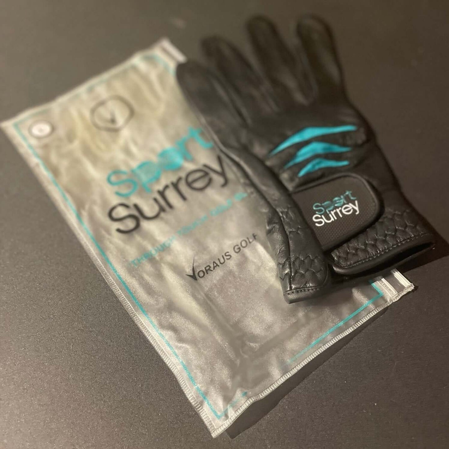 Custom Through Touch Glove displayed alongside protective packaging and logo.