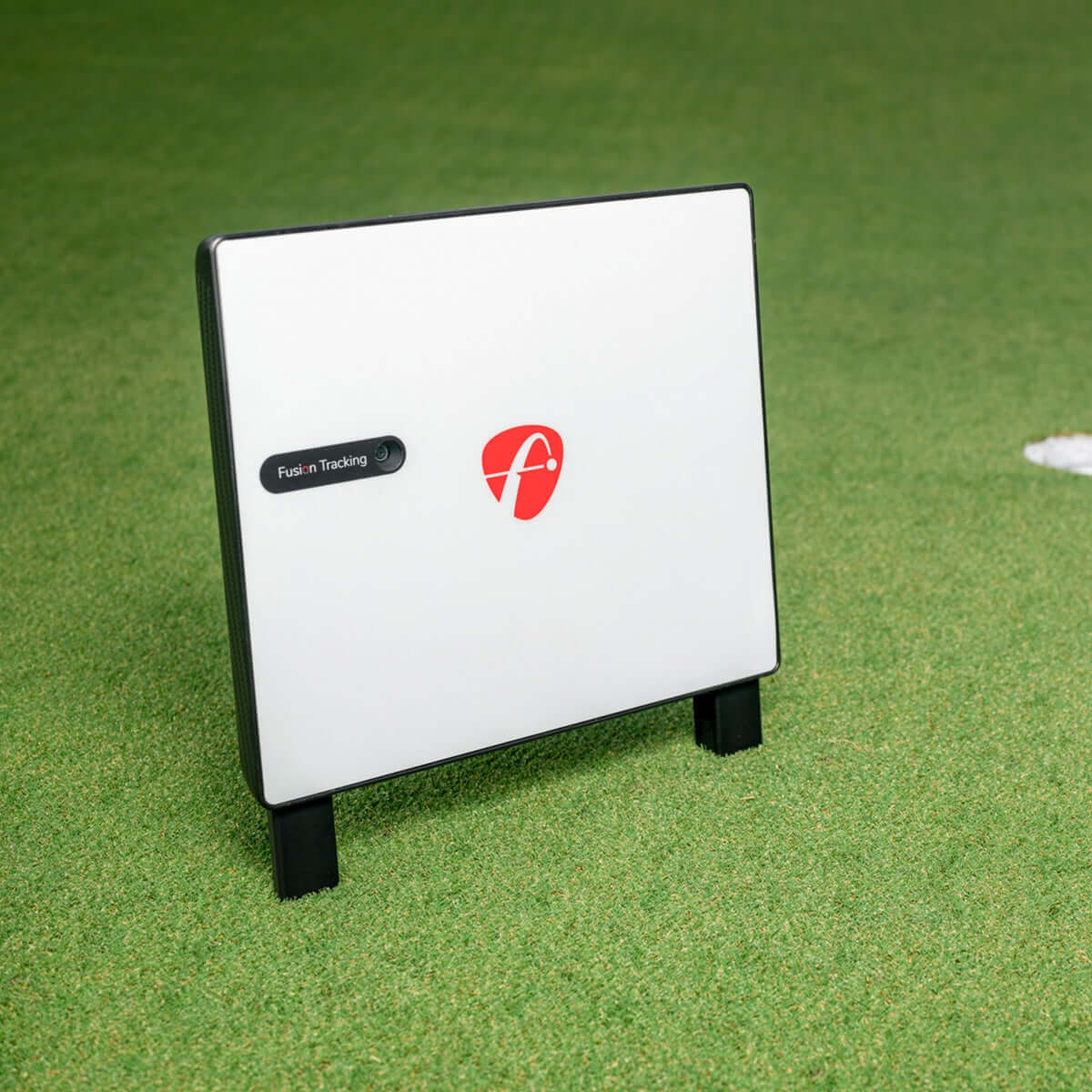 FlightScope X3C tracking radar on a golf course, featuring Fusion Tracking technology for accurate performance data.