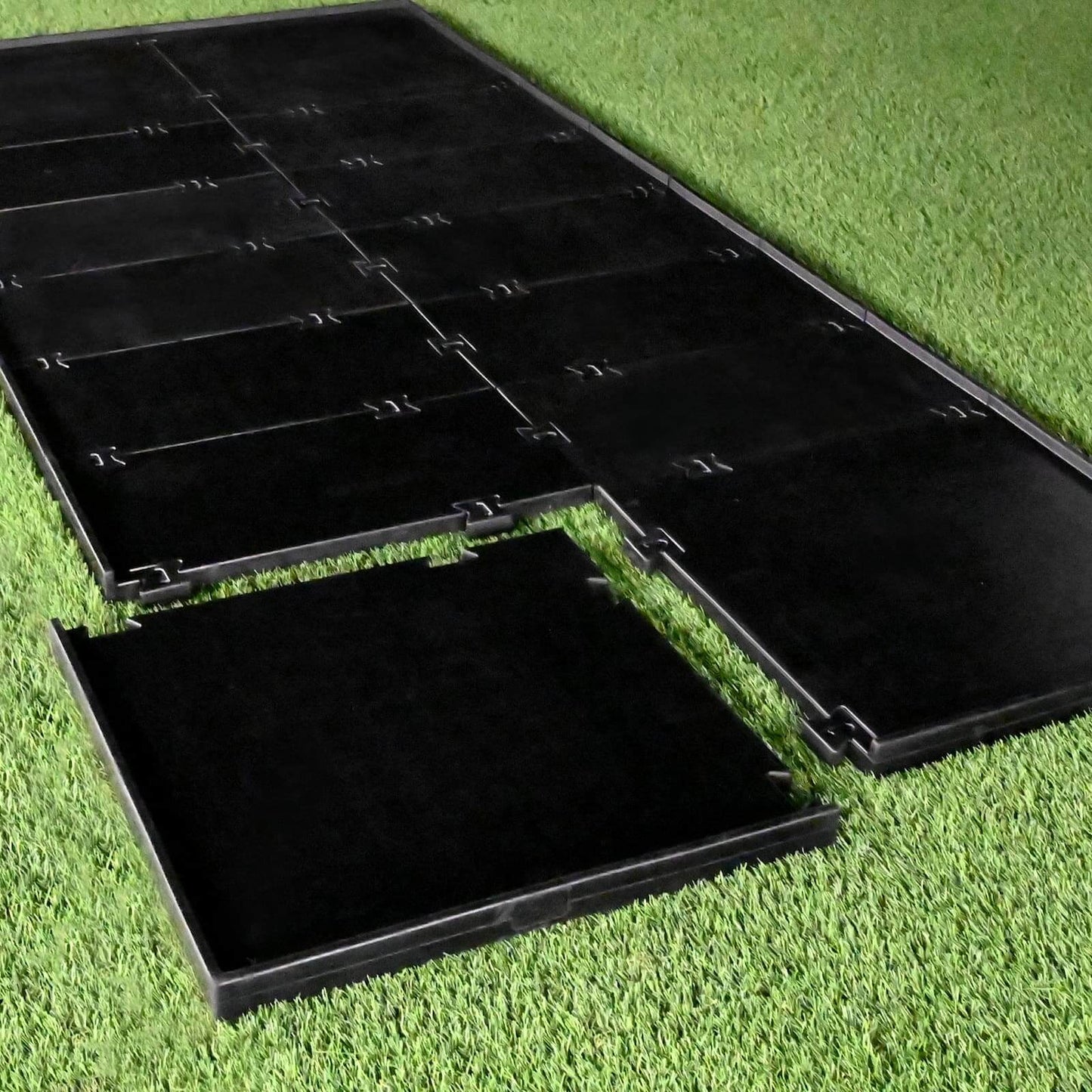 Carl's Place HotShot Golf Mat Base showing a stable, level foundation for golf practice on green grass.