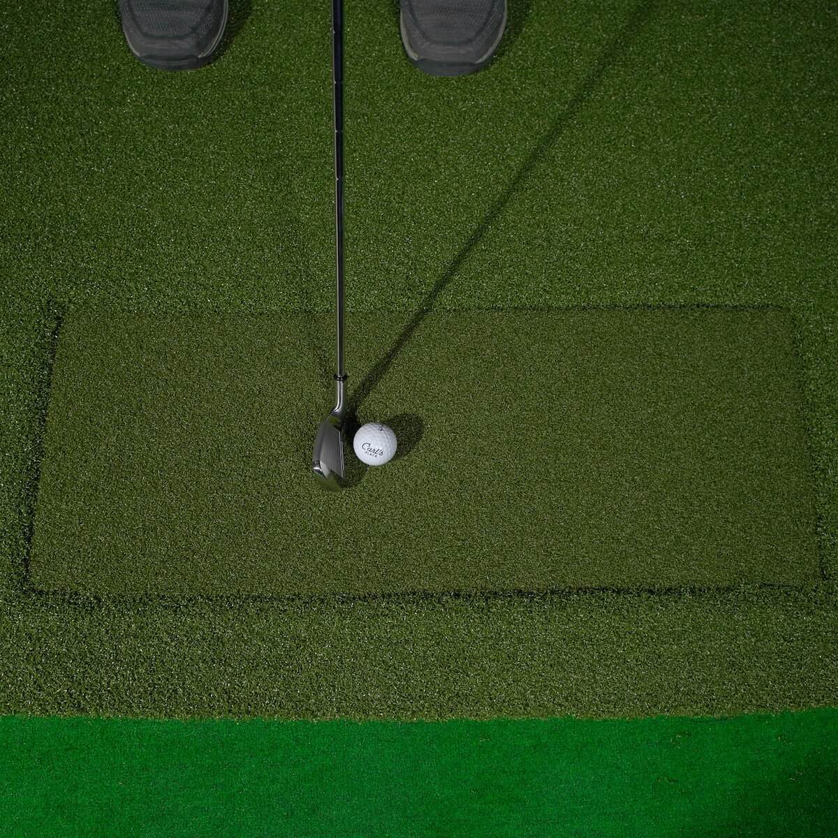 Carl's Place HotShot Golf Hitting Mat with golf club and ball on premium practice surface.