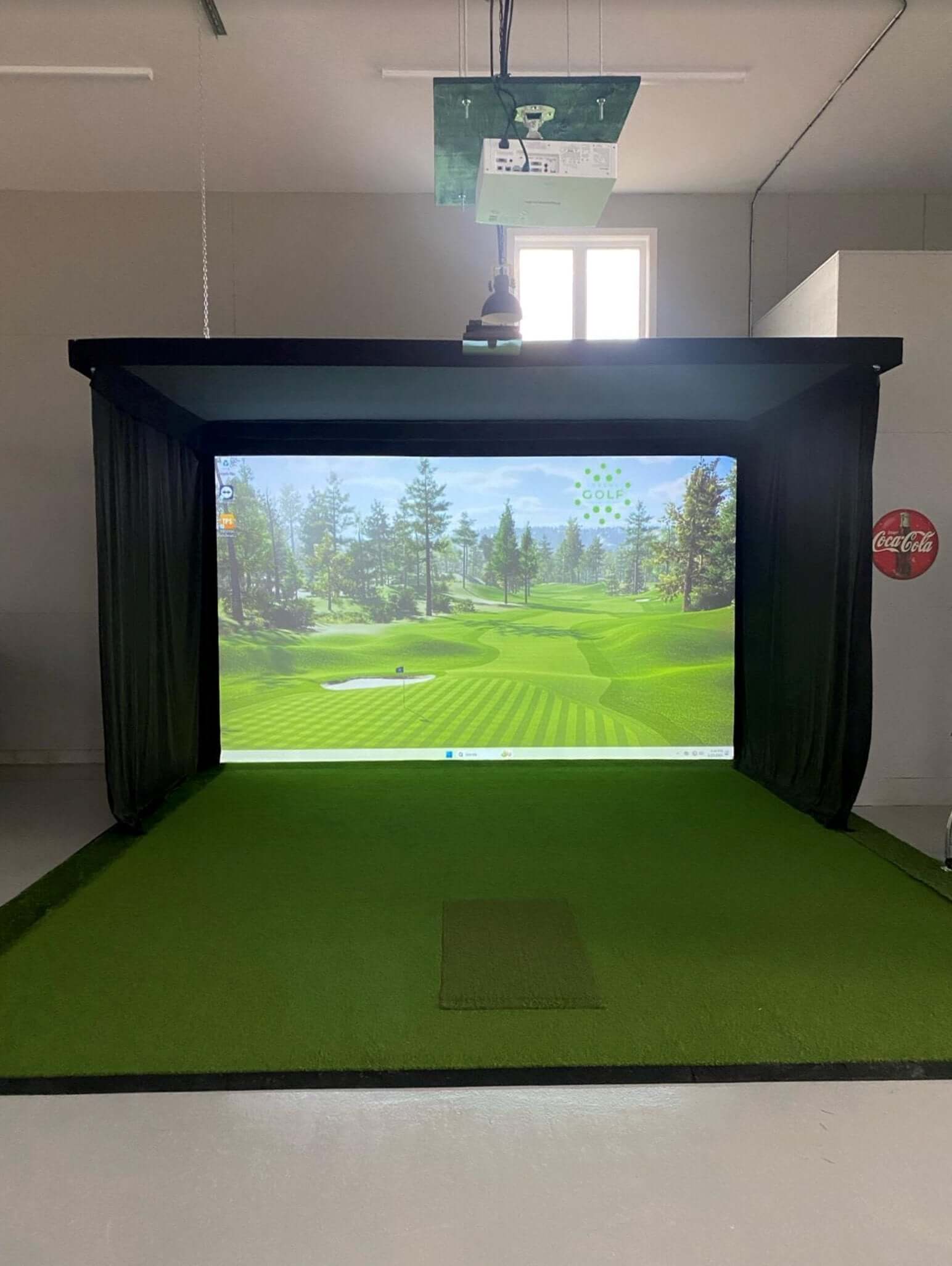 SIG Golf Simulator Curtains surrounding a golf simulator screen in an indoor setting.