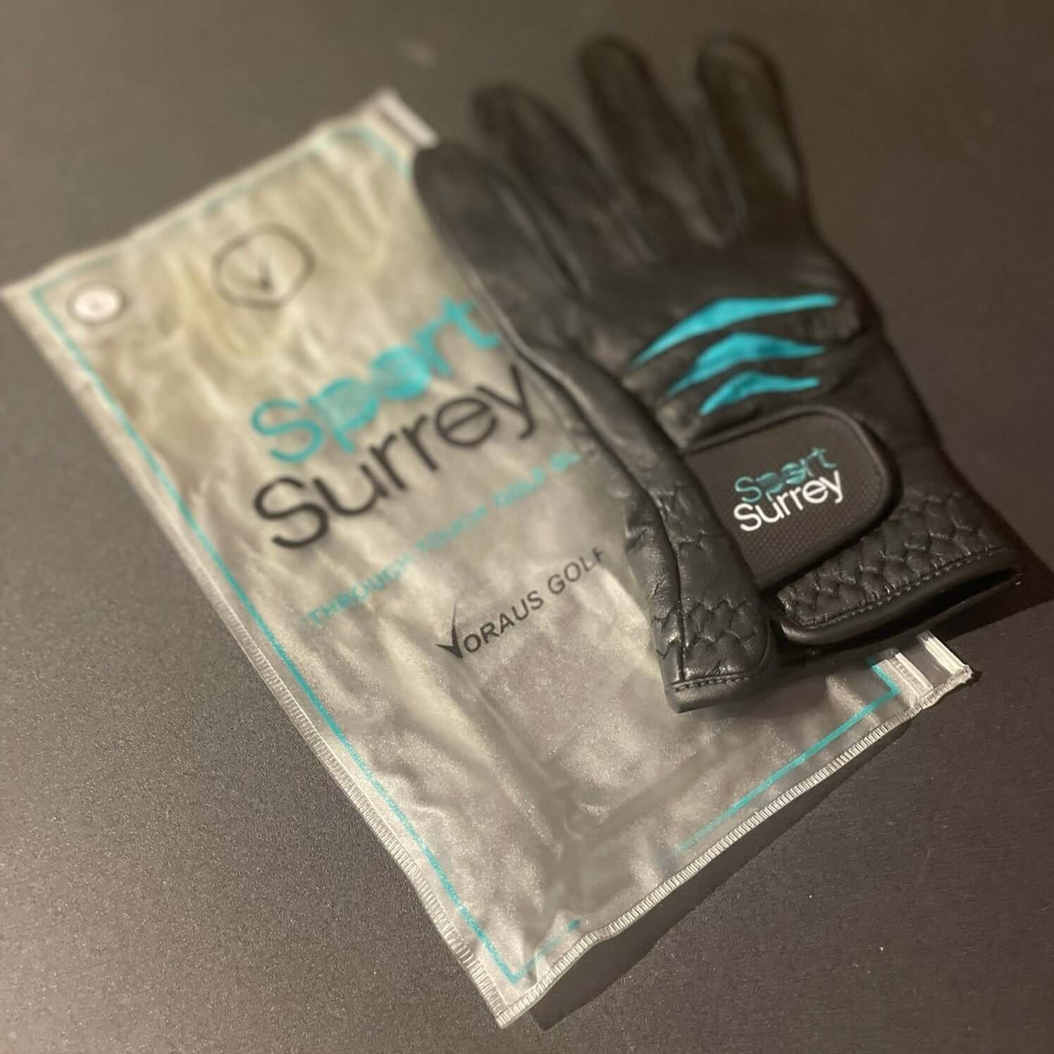 Custom Through Touch Glove displayed alongside protective packaging and logo.