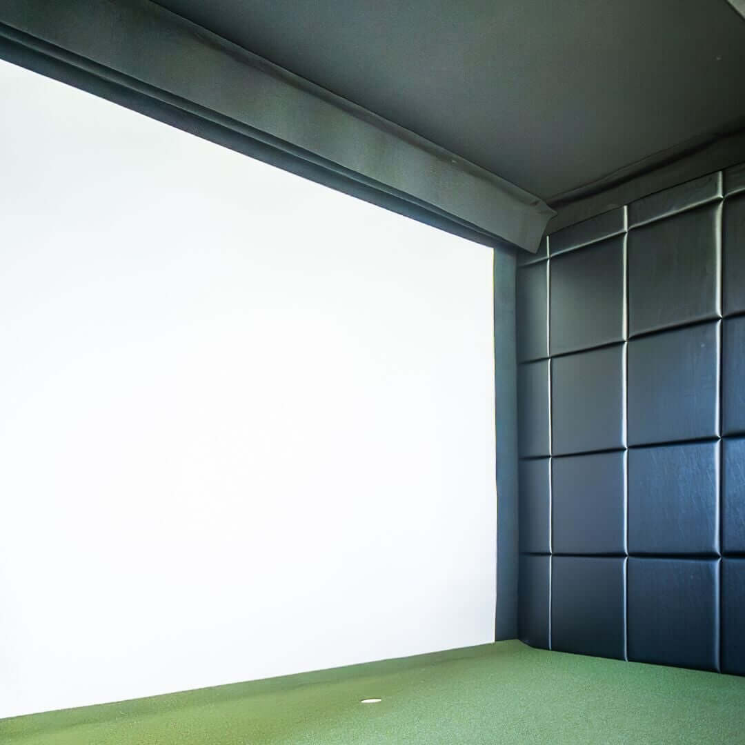 Carpet Panel Gap Pad Golf Simulator Accessory in a golf simulator setup with green turf and impact screen.
