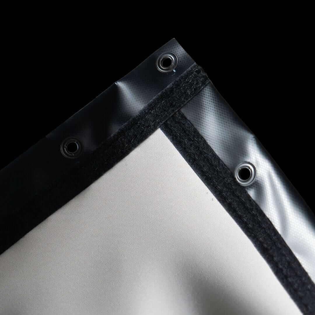 Close-up of SIGPRO Premier Golf Simulator Impact Screen's reinforced edges with grommets for durability.