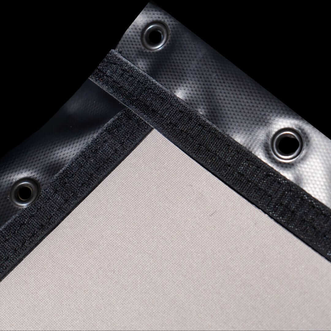 Close-up of the SIGPRO Premier Golf Simulator Impact Screen showing grommets and edge finish details.