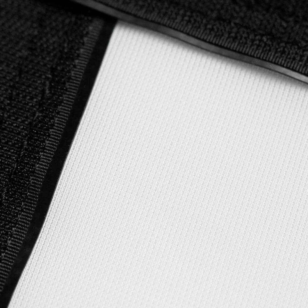 Close-up of the fabric texture showing black and white details of the Golf Simulator Impact Screen - SIGPRO Premium.