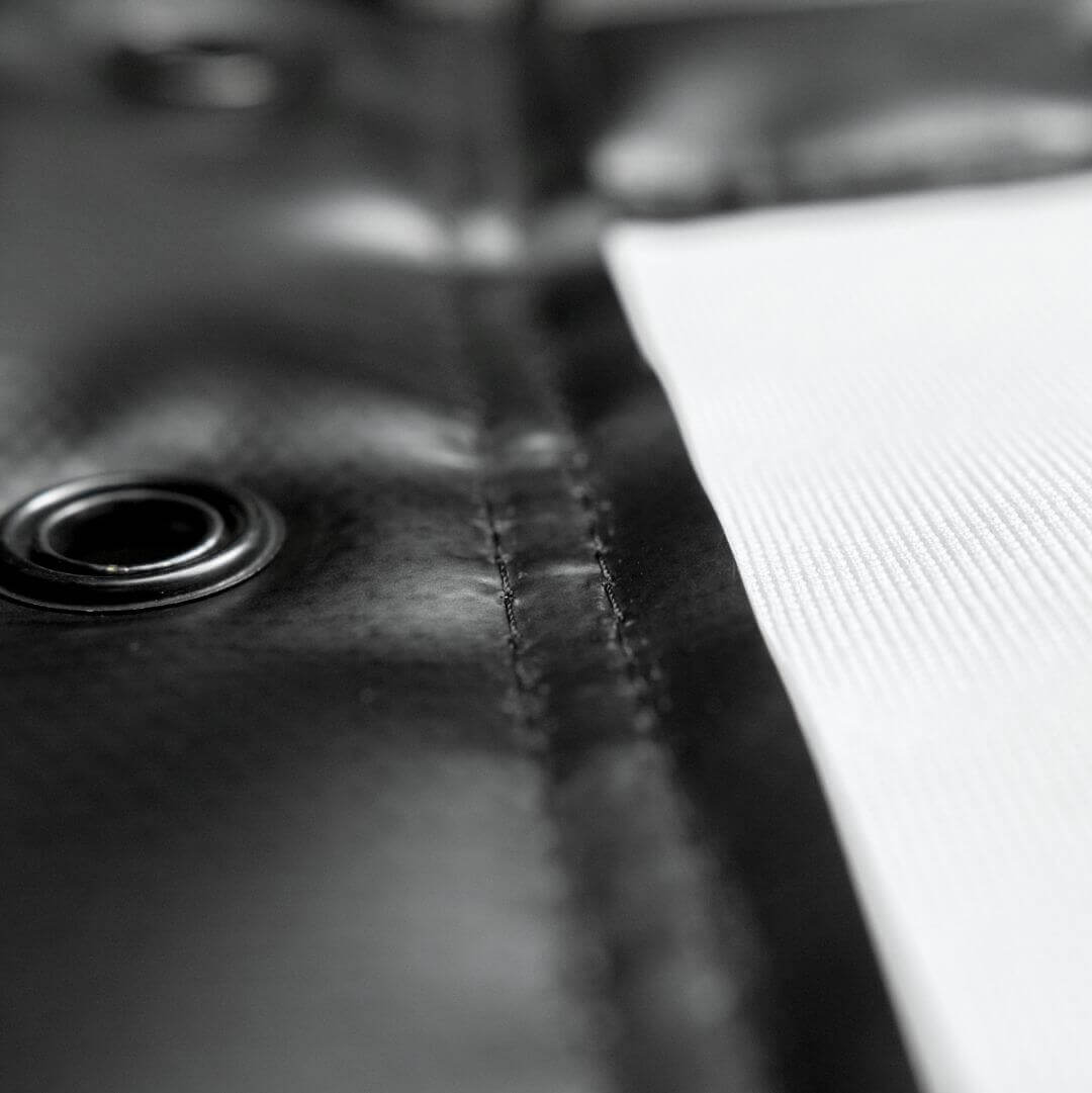 Close-up of the Golf Simulator Impact Screen - SIGPRO Premium showing finished edges and grommet details.