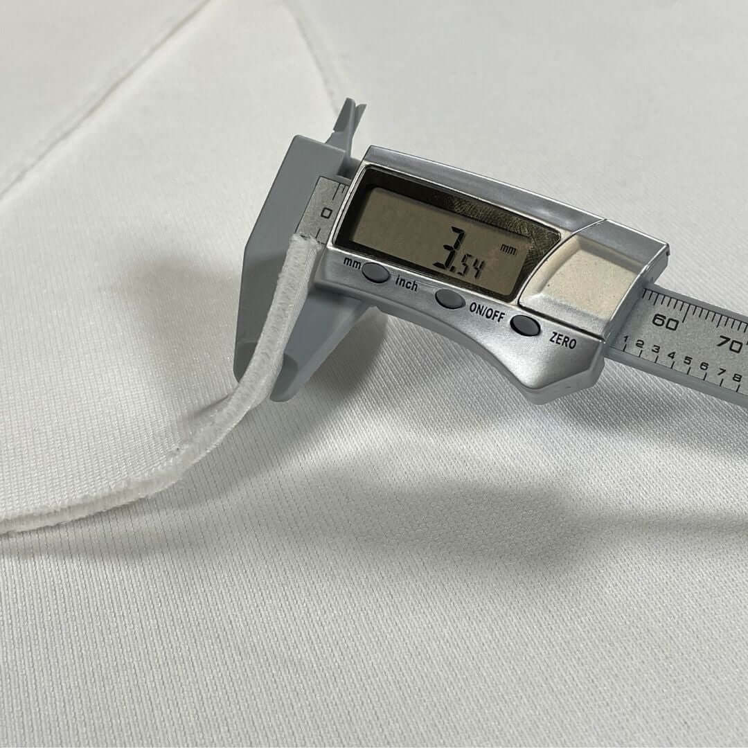 Golf Simulator Impact Screen - SIGPRO Premium showing measurement of material thickness at 7.54 mm.