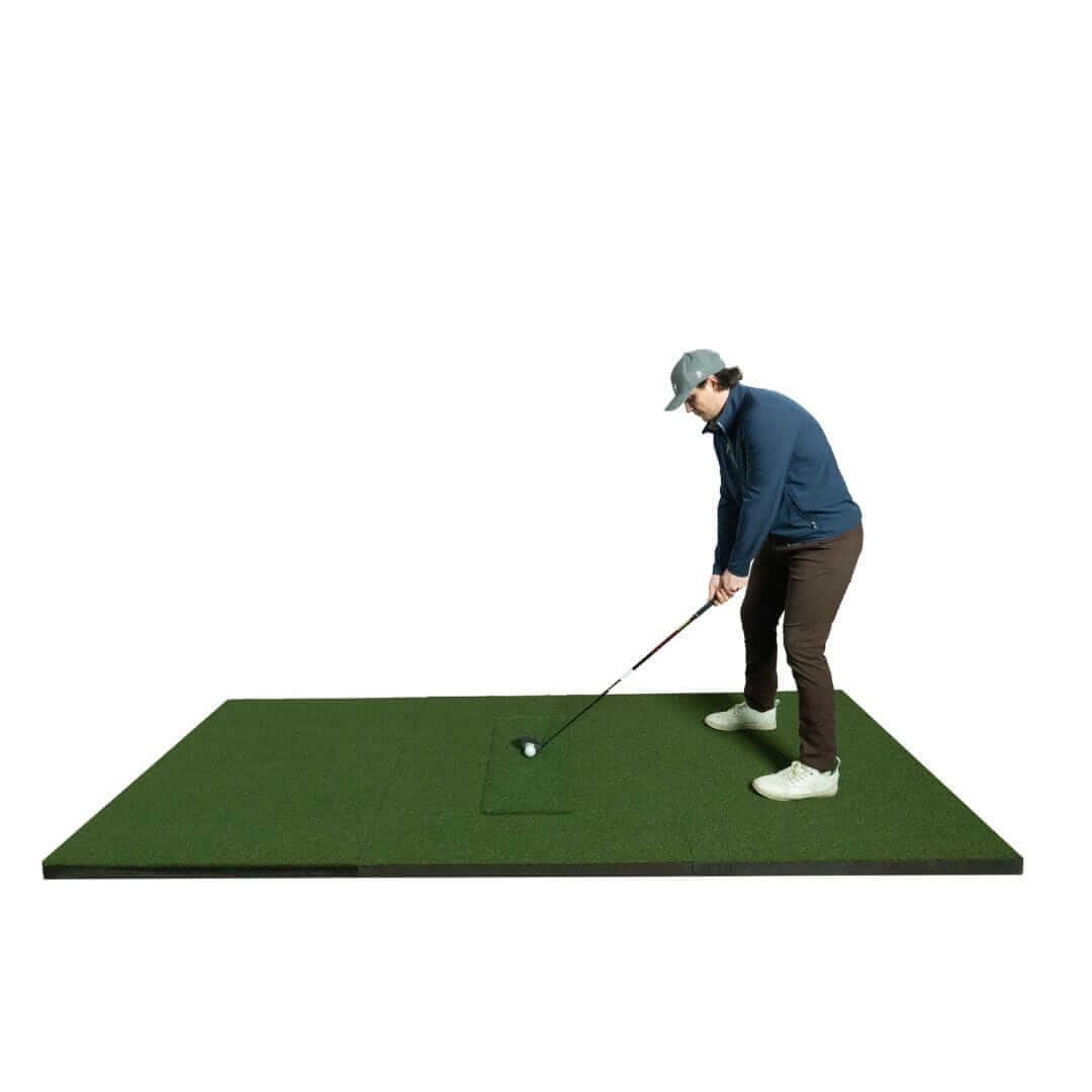 Person practicing golf swing on SIGPRO Softy 4' x 10' Golf Mat with realistic turf surface.