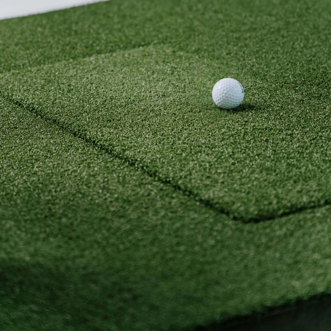 SIGPRO Softy 4' x 10' Golf Mat with a white golf ball resting on the artificial turf surface.